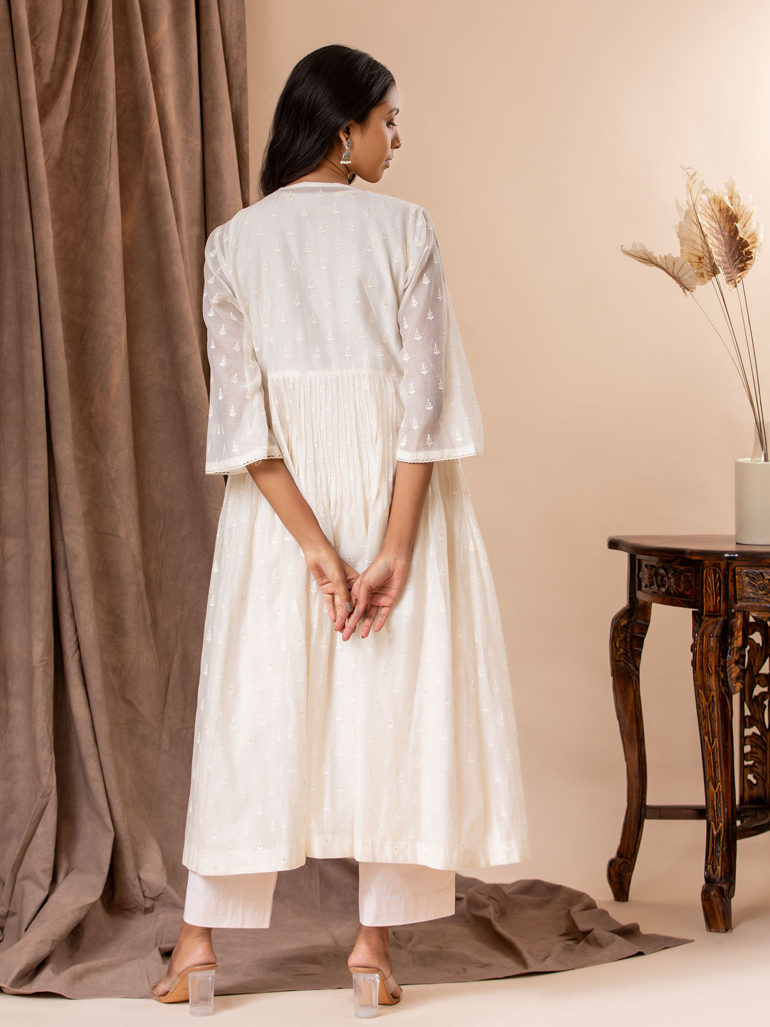 Ivory self-thread bhuti coatstyle top with a hand embroidery detailing, paired with a slip and pants