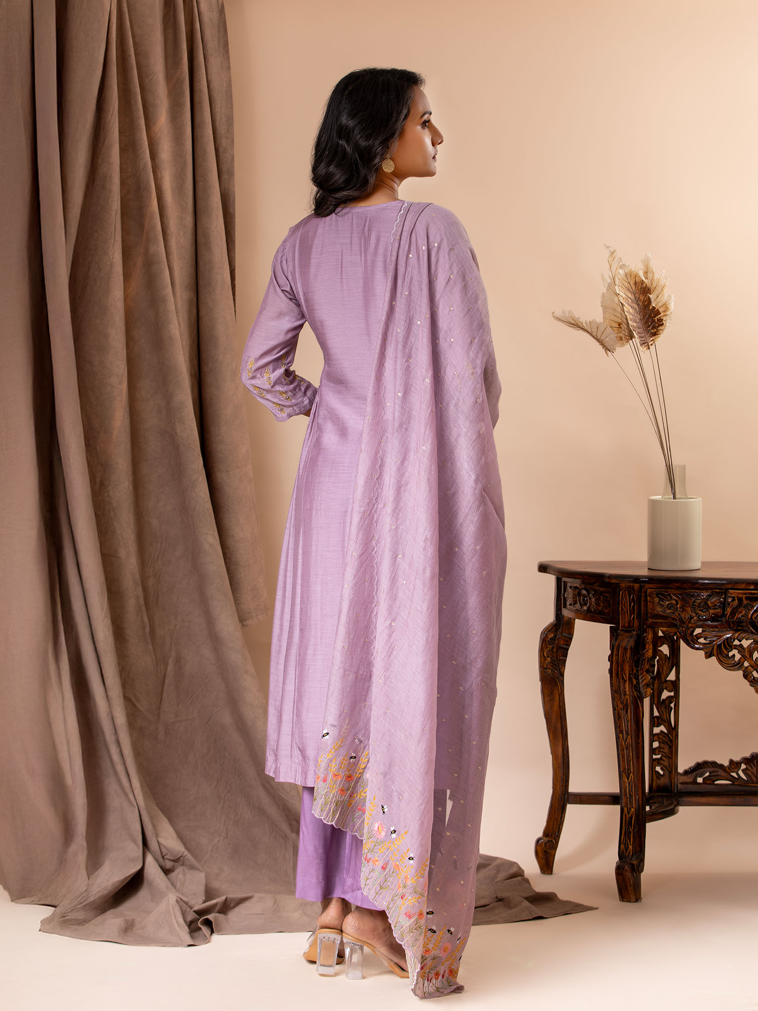 Light purple muslin top with gathered details on the sides and hand embroidery work, paired with a Chanderi embroidered dupatta along with pants.