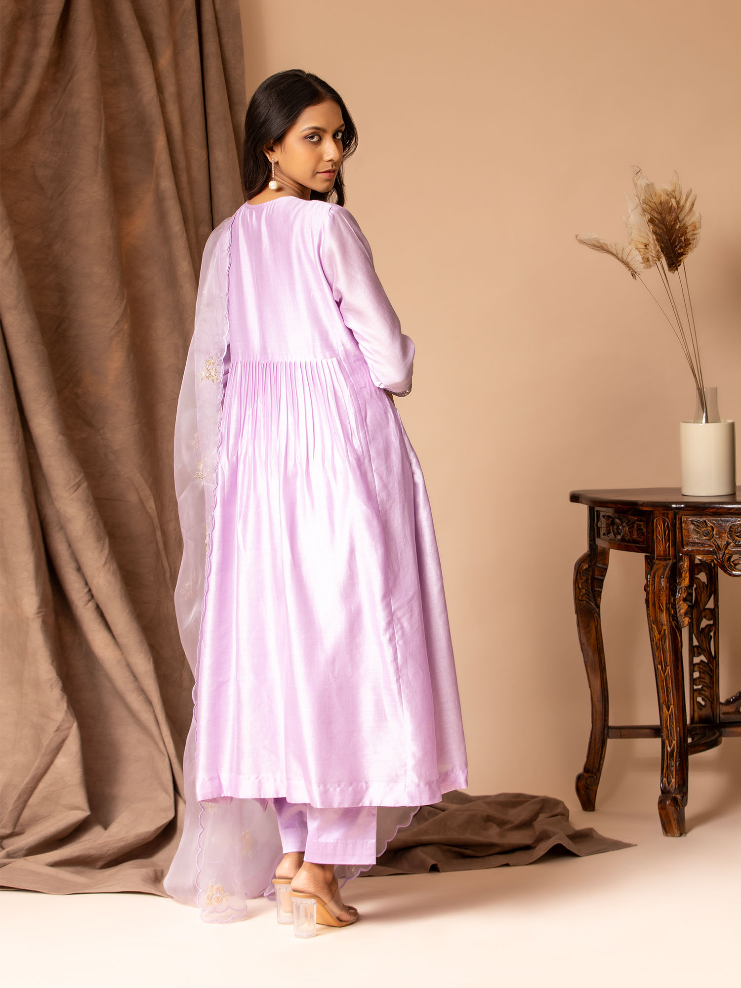 Lilac Chanderi top with panel and gathers, featuring sequin hand embroidery work detailing, paired with an organza dupatta highlighted with handwork bhuttis and matching pants