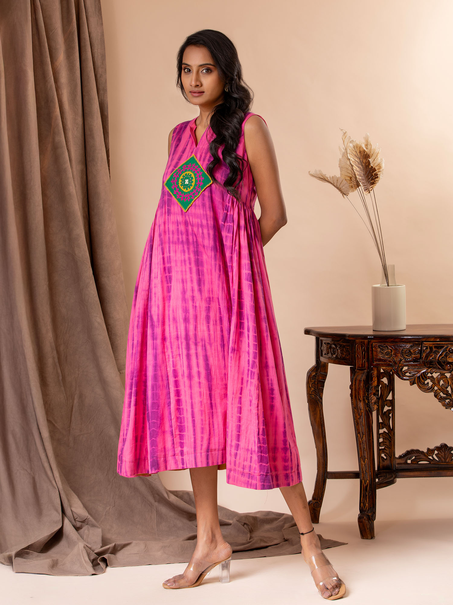 Pink mul tie-and-dye (Shibori) panel frock with gathers on the sides and Kutch work detailing.