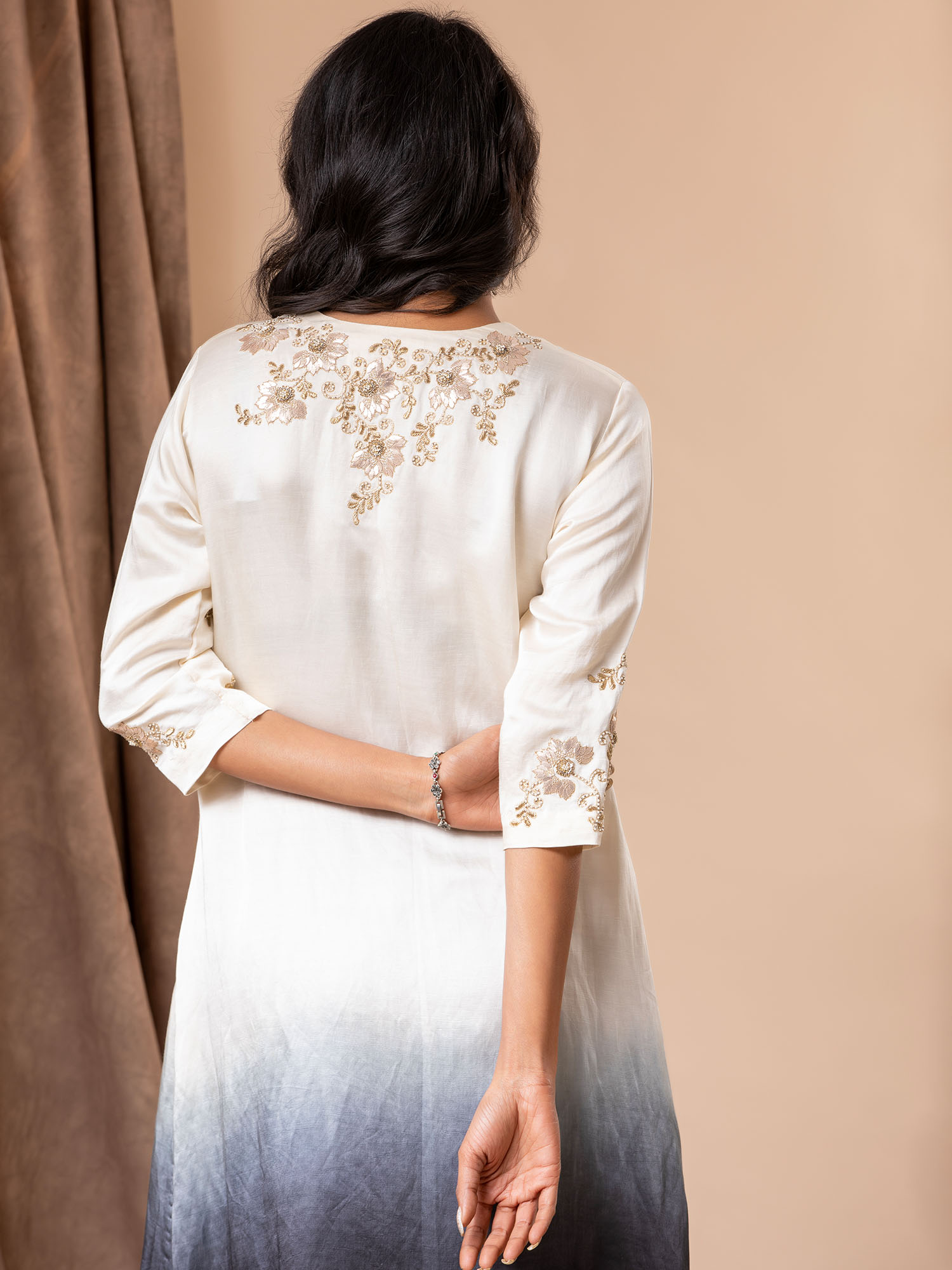 White to black ombre-shaded linen satin straight-cut top with detailed Gota hand embroidery, paired with black pants.